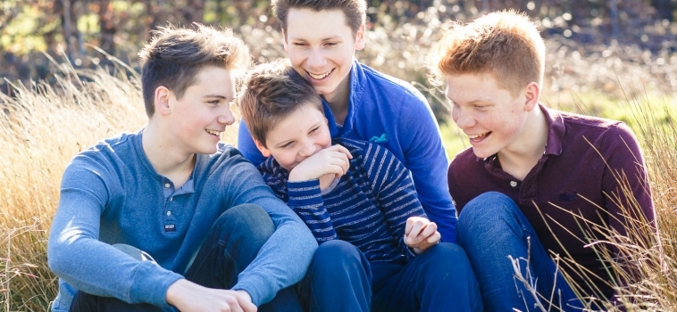 A family photo shoot outdoors with teenagers